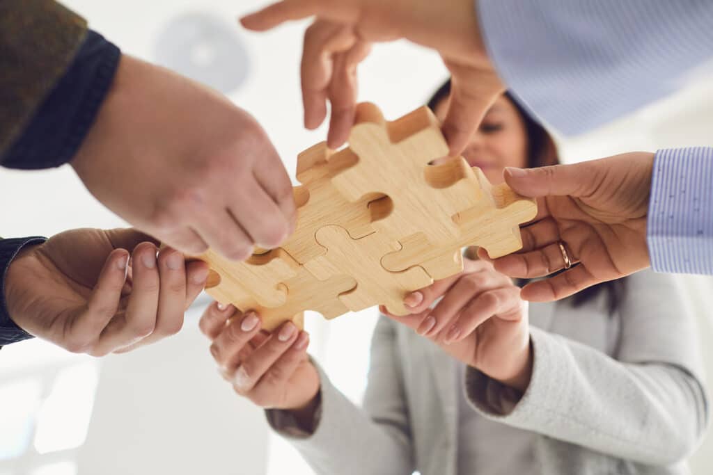 Business people holding puzzle piece in hands