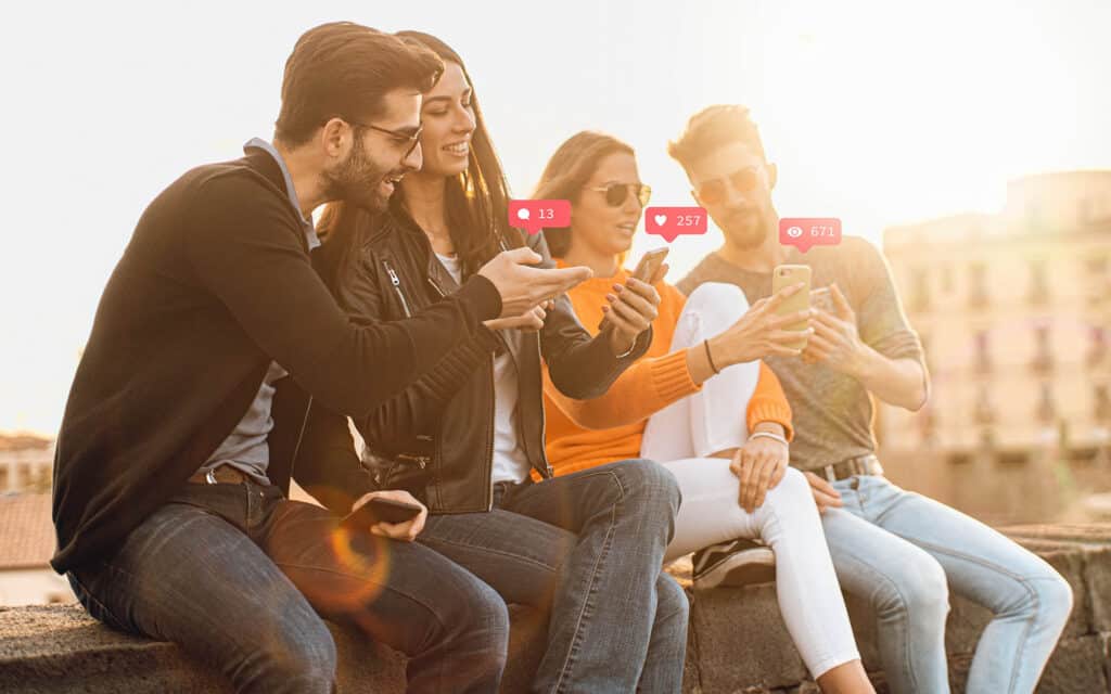 Young people using social network on their smartphone outdoors.